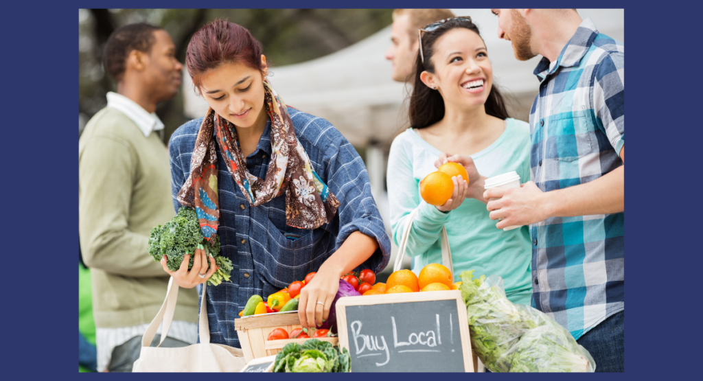 Two women and a man shopping for produce at a local famers market